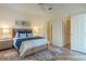 Comfortable bedroom features natural light, wooden floors, ceiling fan and an open closet at 2765 Arugula Dr, North Port, FL 34289