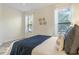 Bright bedroom featuring neutral walls, two windows with blinds, and a queen bed at 2765 Arugula Dr, North Port, FL 34289