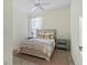 Bright bedroom with a neutral palette, ceiling fan, and a plush area rug at 2765 Arugula Dr, North Port, FL 34289