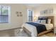 Bedroom with neutral walls, wood-look floors, a queen bed, and natural light at 2765 Arugula Dr, North Port, FL 34289