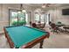 Inviting billiard room with a classic pool table and comfortable seating areas for residents at 2765 Arugula Dr, North Port, FL 34289