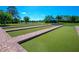 Beautifully maintained bocce ball court with brick trim and shaded seating area at 2765 Arugula Dr, North Port, FL 34289