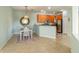 Cozy dining area with a stylish chandelier, a wooden table set and ceramic tile floors at 2765 Arugula Dr, North Port, FL 34289
