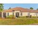 Beautiful home featuring a tile roof and manicured landscaping at 2765 Arugula Dr, North Port, FL 34289