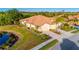 Aerial view showcasing home with manicured landscaping, pond and three car garage at 2765 Arugula Dr, North Port, FL 34289