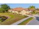 Exterior shot of a well-maintained home with a three-car garage and mature landscaping at 2765 Arugula Dr, North Port, FL 34289