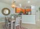Kitchen and dining area featuring wood cabinets, stainless steel appliances, and a modern chandelier at 2765 Arugula Dr, North Port, FL 34289