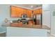 Kitchen featuring wood cabinets, stainless steel appliances, and granite countertops at 2765 Arugula Dr, North Port, FL 34289