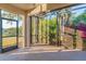Screened lanai offering views of the lush, landscaped backyard and mature trees at 2765 Arugula Dr, North Port, FL 34289
