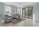 Cozy living room featuring lots of natural light, neutral furniture and sliding glass doors to the outside at 2765 Arugula Dr, North Port, FL 34289