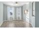 Living room with wood-look floors, neutral paint, and two windows at 2765 Arugula Dr, North Port, FL 34289