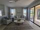 Inviting living room with a ceiling fan, stylish rug, and large sliding glass doors providing lots of natural light at 2765 Arugula Dr, North Port, FL 34289