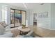 Living room with large sliding glass doors, tile flooring, modern decor and neutral colored furniture at 2765 Arugula Dr, North Port, FL 34289