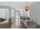 Open floor plan showcasing the seamless flow from kitchen to dining to living area with neutral décor at 2765 Arugula Dr, North Port, FL 34289