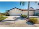 Two-car garage with front yard landscaping at 2765 Arugula Dr, North Port, FL 34289