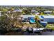 Aerial view of waterfront home with private pool, detached garage, and boat dock at 3111 Buttonwood Pl, Punta Gorda, FL 33950