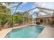 Screened-in swimming pool with surrounding patio at 3164 Broad Ave, North Port, FL 34286