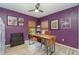 Home office with purple walls, wood desk, and plenty of storage at 3164 Broad Ave, North Port, FL 34286