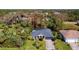 Aerial view of a beautiful home nestled in lush greenery with a screened-in pool area and well-maintained landscaping at 3316 Kacher Rd, North Port, FL 34288