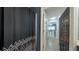 View of a bathroom featuring a decorative shower curtain and a glimpse into the living area with hardwood floors at 3316 Kacher Rd, North Port, FL 34288