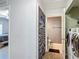 Hallway view of the guest bathroom and laundry room with full-size washer and dryer at 3316 Kacher Rd, North Port, FL 34288