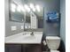 Comfortable bathroom with vanity, toilet, mirror and Starry Night artwork at 3316 Kacher Rd, North Port, FL 34288