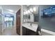 Bathroom features a vanity with a white countertop, modern lighting, and a decorative 'Starry Night' painting at 3316 Kacher Rd, North Port, FL 34288