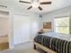 Bedroom with ceiling fan, closet, and window allowing lots of natural light at 3316 Kacher Rd, North Port, FL 34288