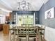 Contemporary dining area with modern light fixture and view of the kitchen and backyard at 3316 Kacher Rd, North Port, FL 34288