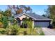 Charming single-story home with a well-manicured lawn, mature landscaping, and attached two-car garage at 3316 Kacher Rd, North Port, FL 34288