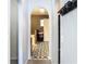 Arched hallway leading to a bathroom with black and white patterned tile flooring and a modern vanity at 3316 Kacher Rd, North Port, FL 34288