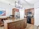 Well-appointed kitchen featuring an island, stainless steel appliances, and ample cabinet space for storage at 3316 Kacher Rd, North Port, FL 34288