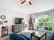 Cozy living room with a large window offering natural light and a comfortable seating area with stylish décor at 3316 Kacher Rd, North Port, FL 34288