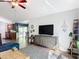 Cozy living area with modern TV console, ceiling fan, and open access to dining and kitchen at 3316 Kacher Rd, North Port, FL 34288