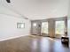 Bright living room with hardwood floors, neutral walls, and vaulted ceiling, illuminated by natural light from two large windows at 3316 Kacher Rd, North Port, FL 34288