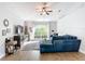 Living room with hardwood floors, a large arched window, a comfortable blue sofa, and decorative shelving at 3316 Kacher Rd, North Port, FL 34288