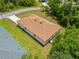 Aerial view of the backyard showing the house layout, grassy area, and nearby trees at 3390 Nadasky Ave, North Port, FL 34288