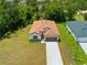 Aerial view of a single-Gathering home with a brown roof, attached garage, and well-maintained lawn at 3390 Nadasky Ave, North Port, FL 34288