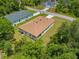 Aerial view of the home with a long driveway surrounded by trees, showcasing the house's setting at 3390 Nadasky Ave, North Port, FL 34288