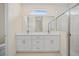 Elegant bathroom featuring double sinks, quartz countertops, and a glass-enclosed shower at 3390 Nadasky Ave, North Port, FL 34288