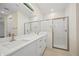 Modern bathroom featuring a double vanity, sleek countertops, and a glass-enclosed shower at 3390 Nadasky Ave, North Port, FL 34288