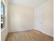 Bright bedroom featuring wood-look floors, neutral walls, and a white door at 3390 Nadasky Ave, North Port, FL 34288
