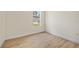 Cozy bedroom with wood flooring, a window for natural light, and neutral decor, perfect for relaxation at 3390 Nadasky Ave, North Port, FL 34288