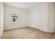 Cozy bedroom featuring wood-look floors, neutral walls, and a double door closet at 3390 Nadasky Ave, North Port, FL 34288