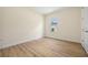 Inviting bedroom featuring wood-look floors, neutral walls, and a bright window at 3390 Nadasky Ave, North Port, FL 34288