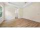 Bright bedroom featuring wood-look floors, neutral walls, and access to the en-suite bathroom at 3390 Nadasky Ave, North Port, FL 34288