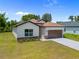 Charming single-story home featuring a two-car garage and manicured landscaping, and a well-maintained lawn at 3390 Nadasky Ave, North Port, FL 34288
