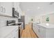 Stylish kitchen showcasing stainless steel appliances, white cabinets, and a sleek island with quartz countertops at 3390 Nadasky Ave, North Port, FL 34288