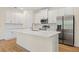 Bright kitchen features stainless steel appliances, white cabinets and subway tile back splash at 3390 Nadasky Ave, North Port, FL 34288
