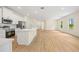 Open-concept kitchen and living area with modern appliances, an island, and wood flooring at 3390 Nadasky Ave, North Port, FL 34288